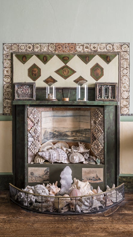 The original fireplace, bordered by the feather frieze, in the Drawing Room at A la Ronde, Devon.
